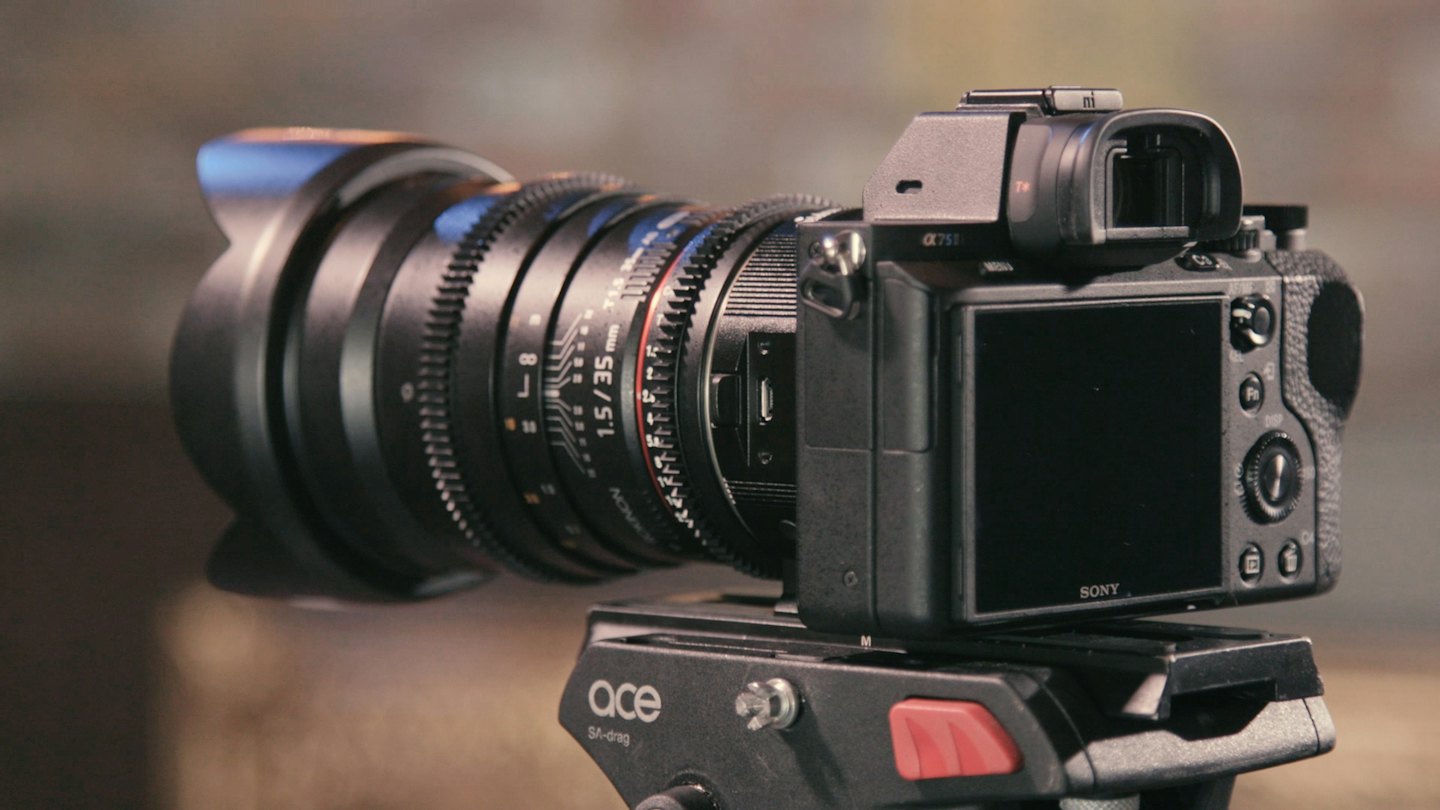 Professional camera with cinematic lens mounted on tripod.