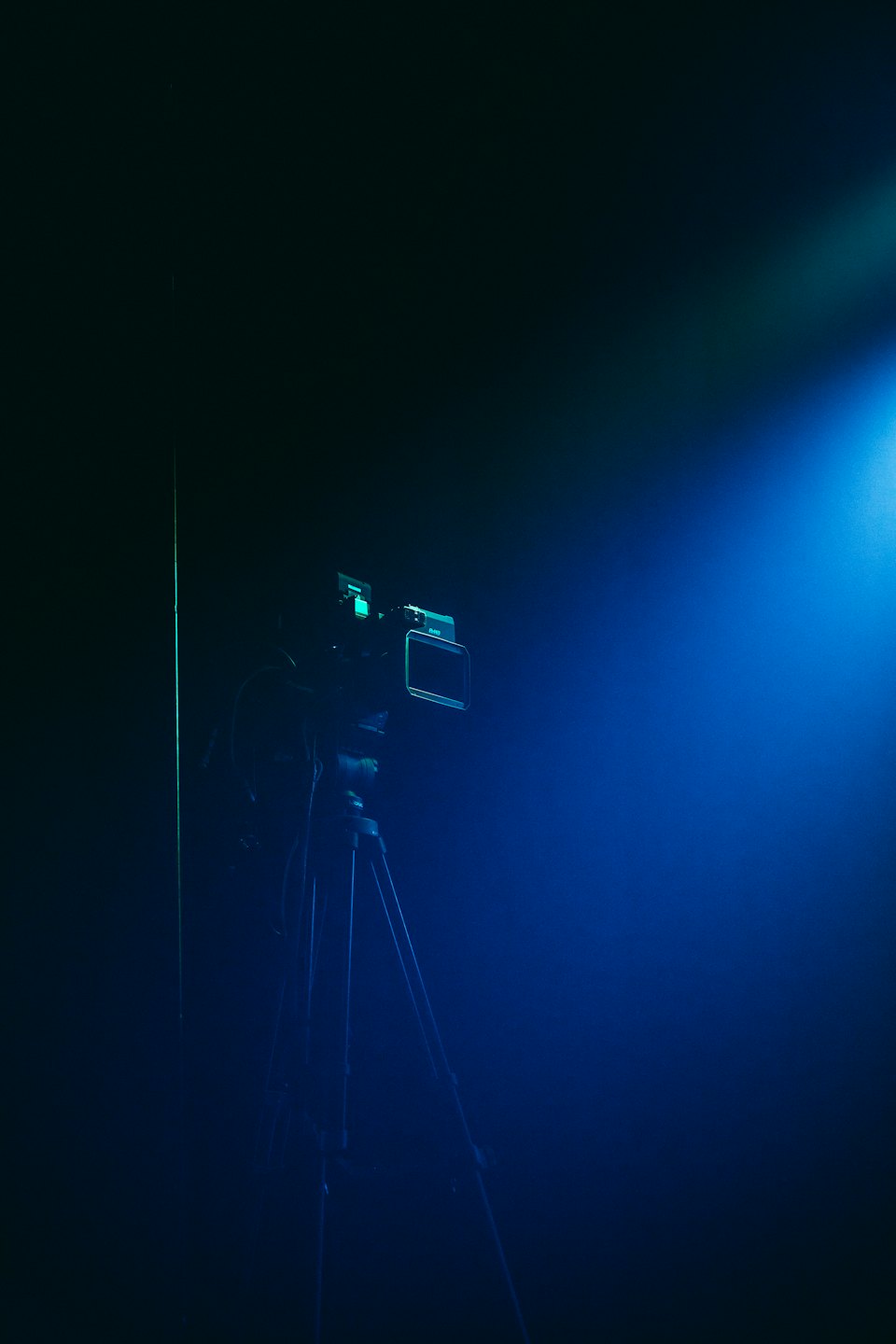 Professional video camera on tripod in studio.